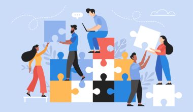 Illustration of people stacking large colorful puzzle pieces together.