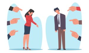 The image shows two individuals standing apart, each surrounded by multiple hands pointing fingers at them. The individual on the left is a person with long hair wearing a red blazer and a dark skirt, covering their face with one hand and lowering the other. The individual on the right is a person with short hair wearing a suit and tie, looking downwards with slumped shoulders.