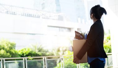 Unemployed woman leaving office building