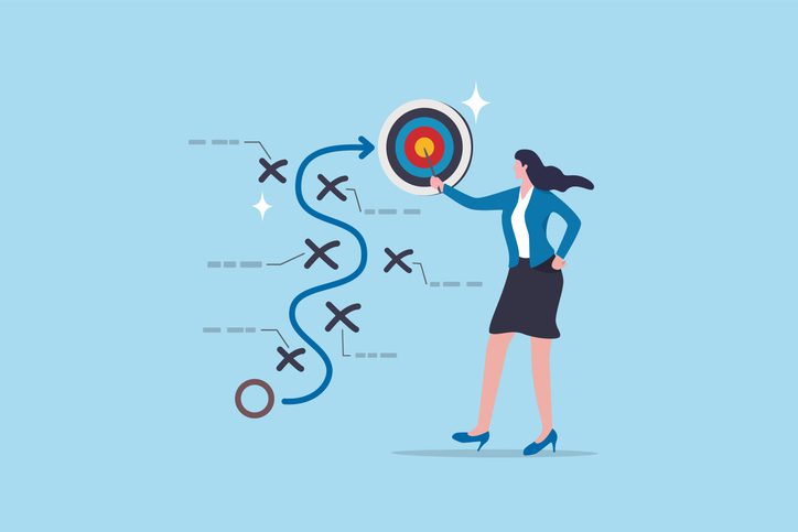 Business professional pointing to a bullseye target, illustrating strategic planning and goal achievement with a winding path and markers.