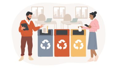 Illustration of a man in a red sweater and brown pants holding a tablet and placing papers into a blue recycling bin, alongside a woman in a pink top and blue skirt holding a phone and throwing a tissue into a yellow bin. Three bins—blue, red, and yellow—each display a white recycling symbol, set in an office with desks and laptops in the background.