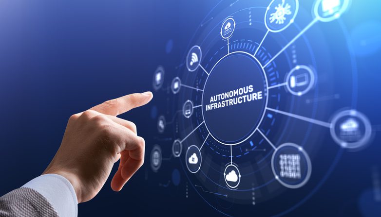 A hand points toward a glowing digital interface displaying a central circle labeled “Autonomous Infrastructure,” surrounded by interconnected icons representing cloud computing, security, data, networking, and AI on a blue, futuristic background.